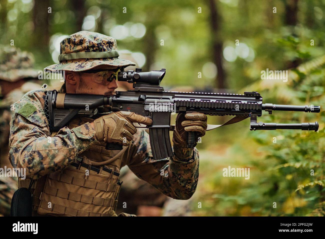 A modern warfare soldier on war duty in dense and dangerous forest ...