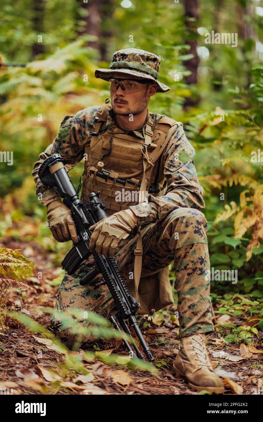 A modern warfare soldier on war duty in dense and dangerous forest ...