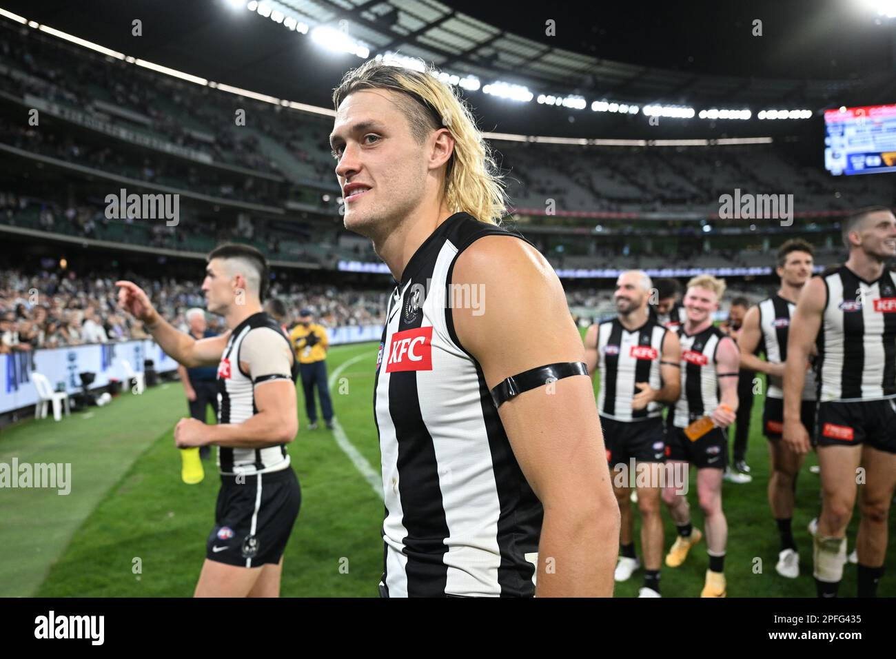 Darcy Moore of Collingwood leads the team off the field after defeating