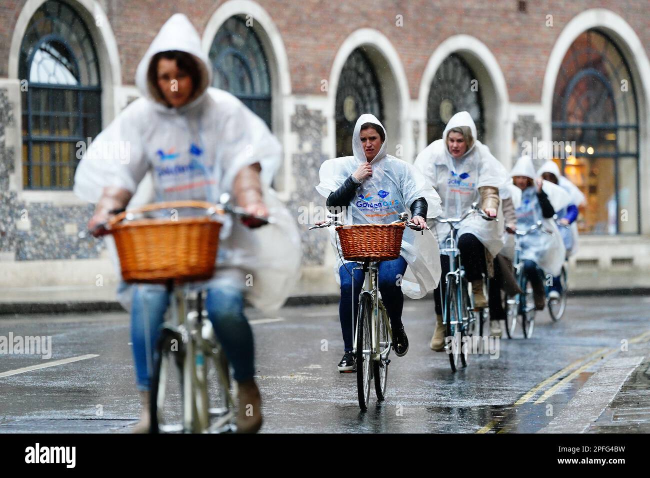 Cyclists in Westminster, London, as they cycle in the rain. Picture date: Friday March 17, 2023. Stock Photo