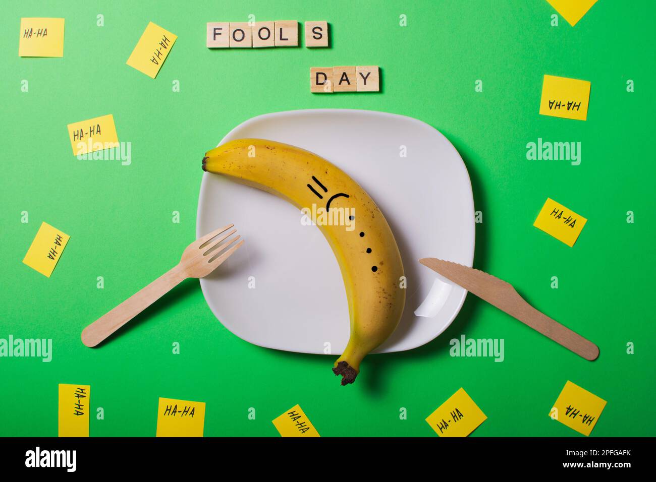 A creative picture of April Fools' Day jokes. Replacing food with similar items. Use of wooden forks and knives. Images of other objects are not what Stock Photo