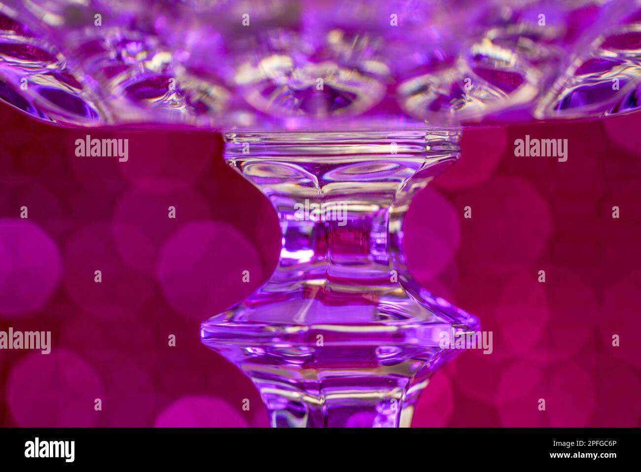 Glass made of crystallike materials photographed in the studio with colorful background Stock