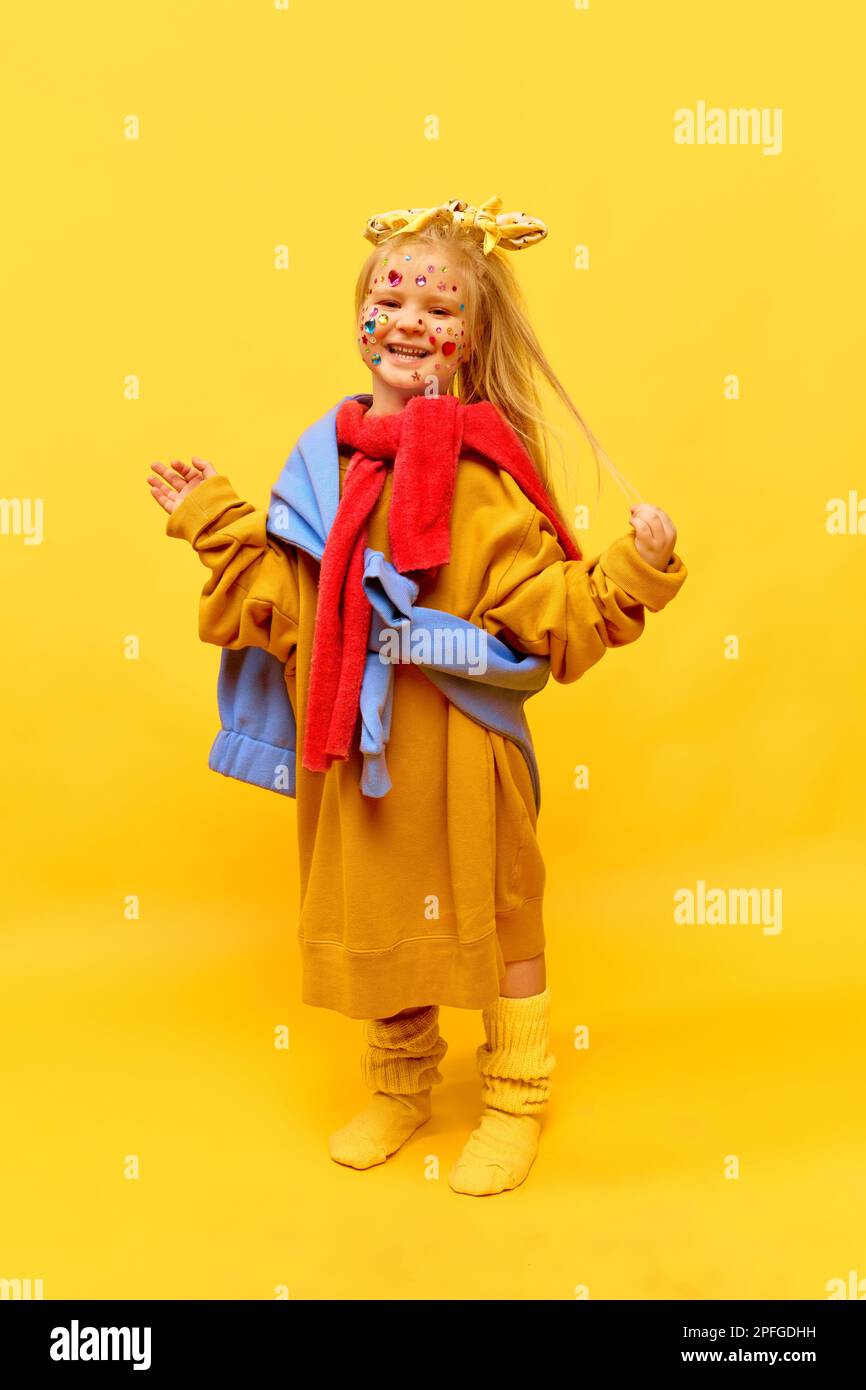 Fulllength photo of little girl standing and wearing big clothes