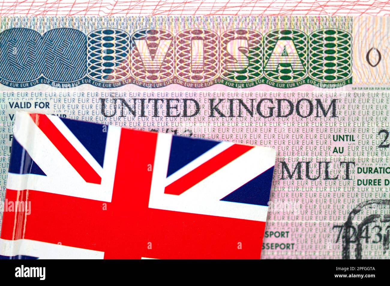 Close-up of United Kingdom visa in passport with Flag of the UK, conceptual political picture Stock Photo