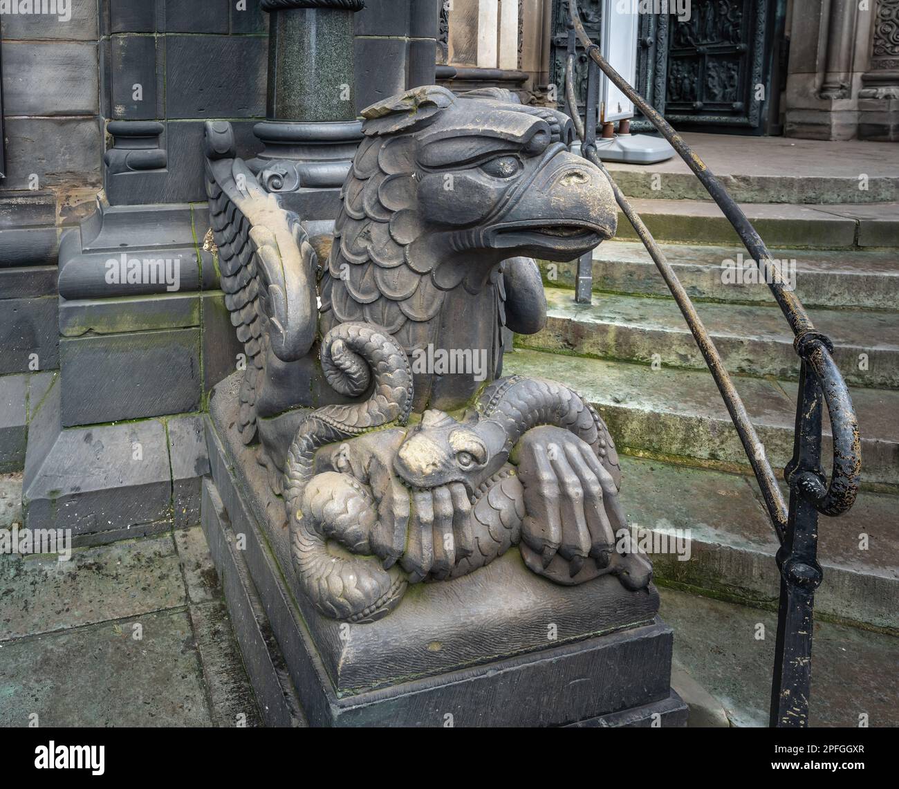 Eagle with a snake sculpture in front of Bremen Cathedral - Bremen, Germany Stock Photo