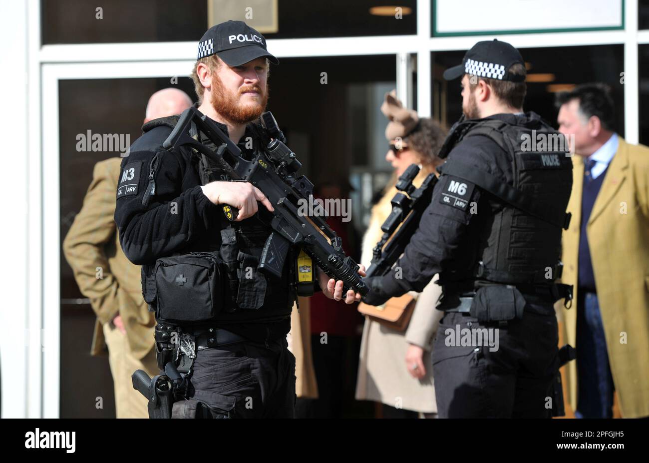 Armed police at the gate as crowds enter Cheltenham Racecourse   Horse racing at Cheltenham Racecourse on Day 4 the final day of the Cheltenham Festiv Stock Photo