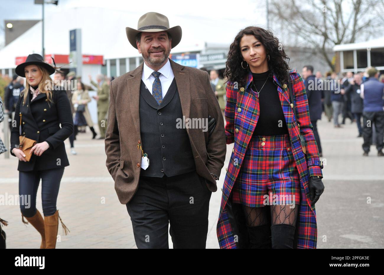 Crowds enter the racecourse including TV presenter from DIY SOS Nick Knowles with girlfriend Katie Dadzie.     Horse racing at Cheltenham Racecourse o Stock Photo