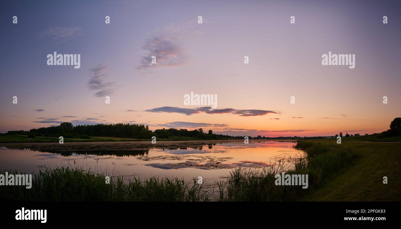 Colorful sunset over the lagoon near the forest Stock Photo - Alamy