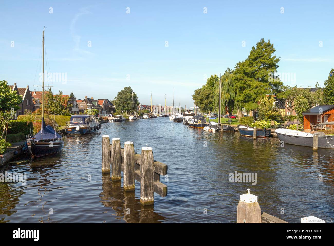 Pleasure boats in the river at the famous Frisian water sports resort Lemmer in the Netherlands. Stock Photo