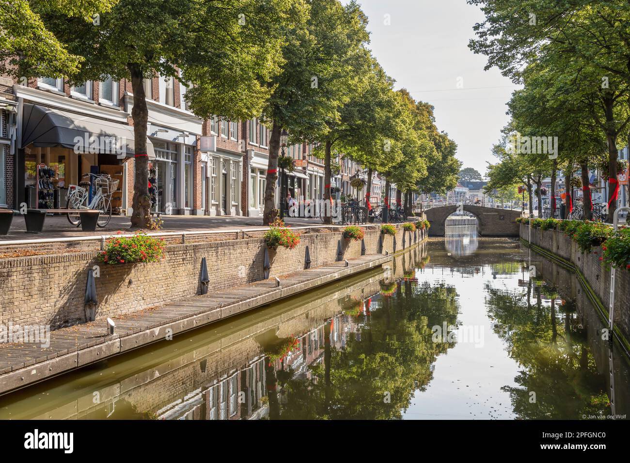 Shopping street along the canal in the center of the city of Harlingen in Friesland. Stock Photo
