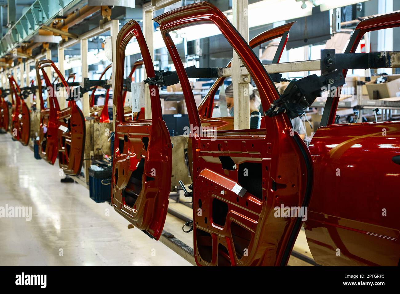 Car doors painted shiny red color in assembling Stock Photo