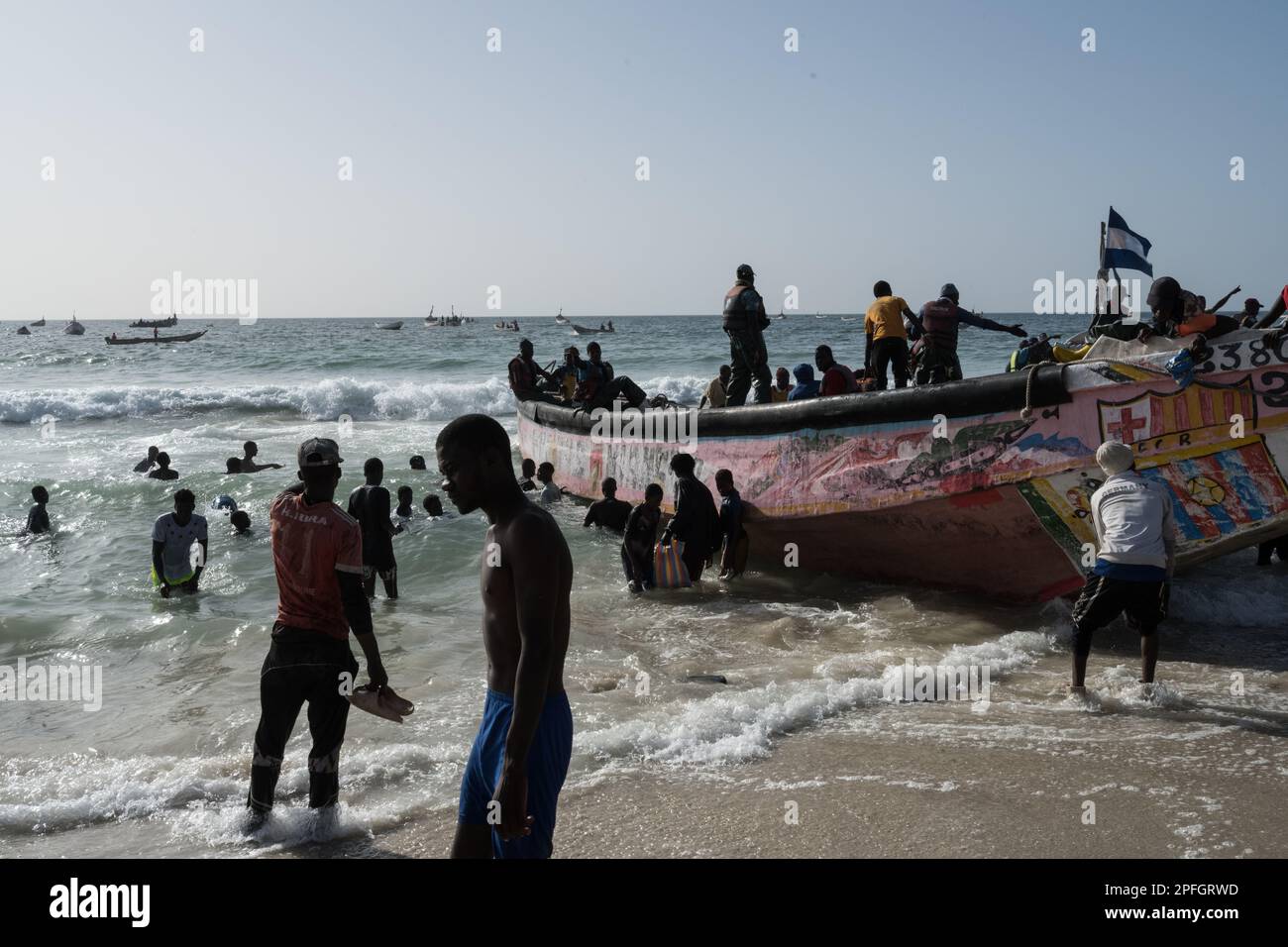 African fishermen unloading the day's catch of fish. Port de Peche, Nouakchott's famous fish market, plage des pecheurs. Mauritania. Stock Photo