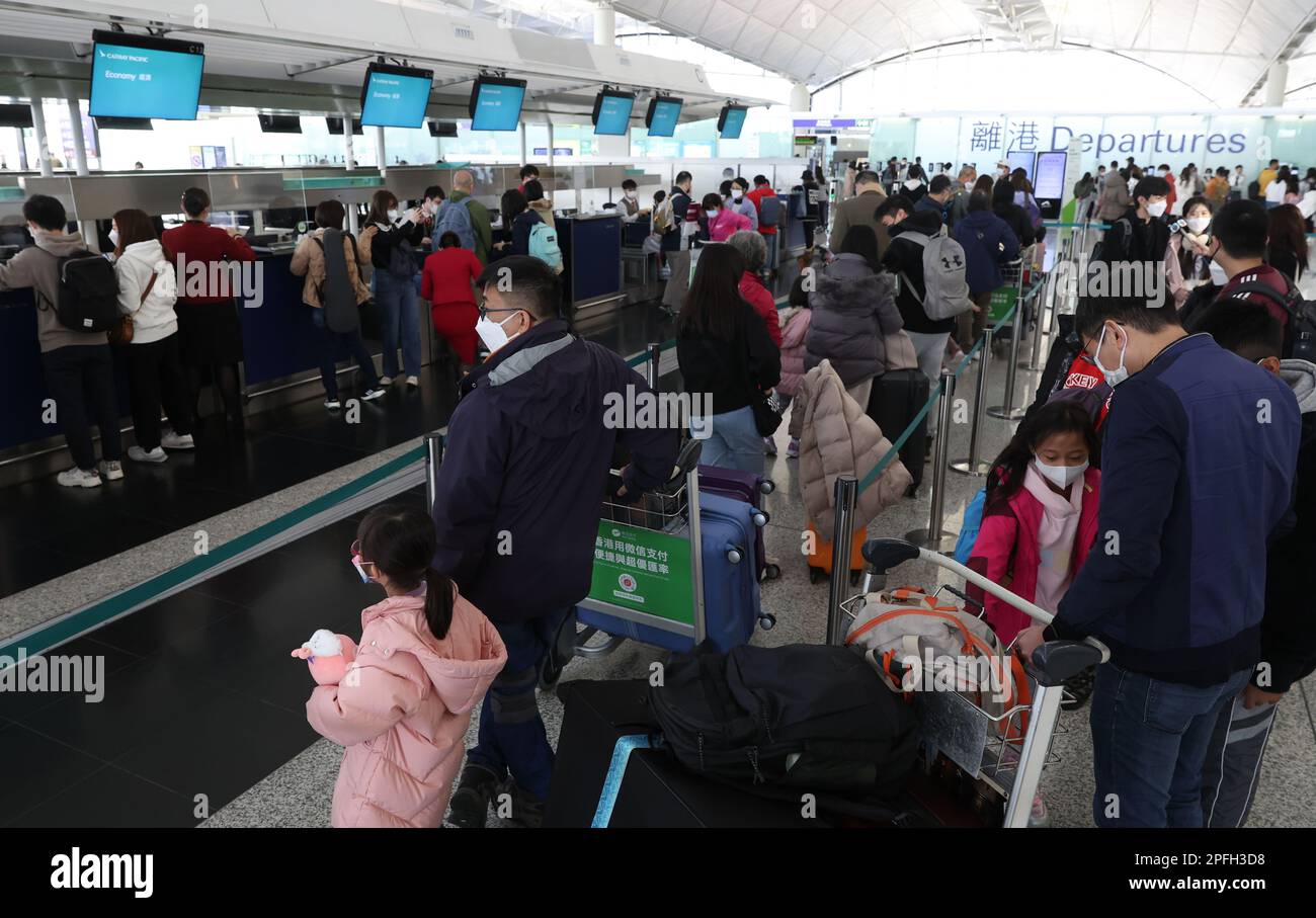 Passengers check in for their flight at the Cathay Pacific Airline Check in counter during the