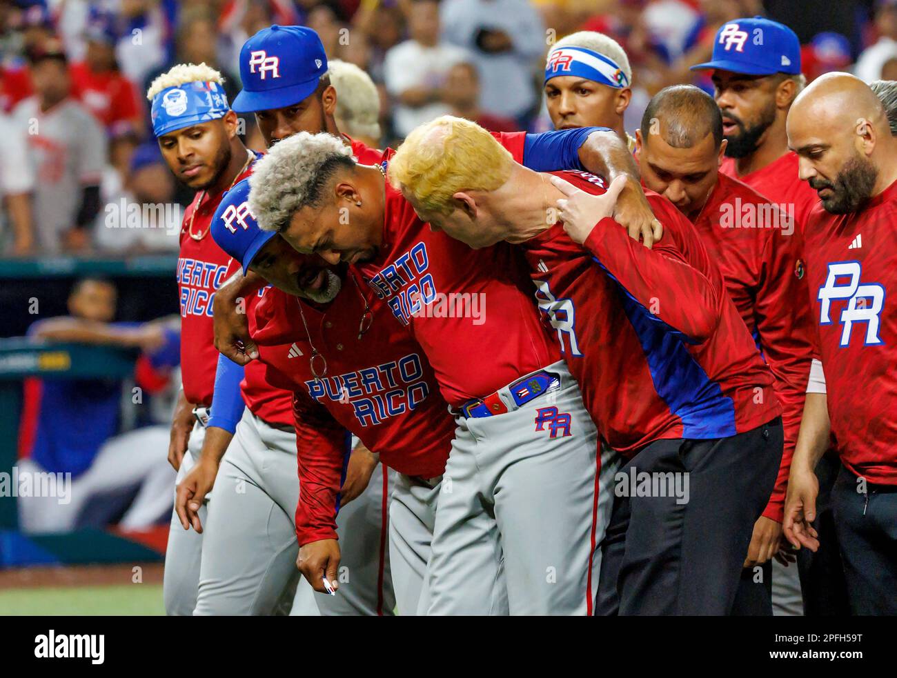 Puerto Rico pitcher Edwin Diaz (39) is being helped by team pitching coach  Ricky Bones and medical staff after the the Pool D game against Dominican  Republic at the World Baseball Classic