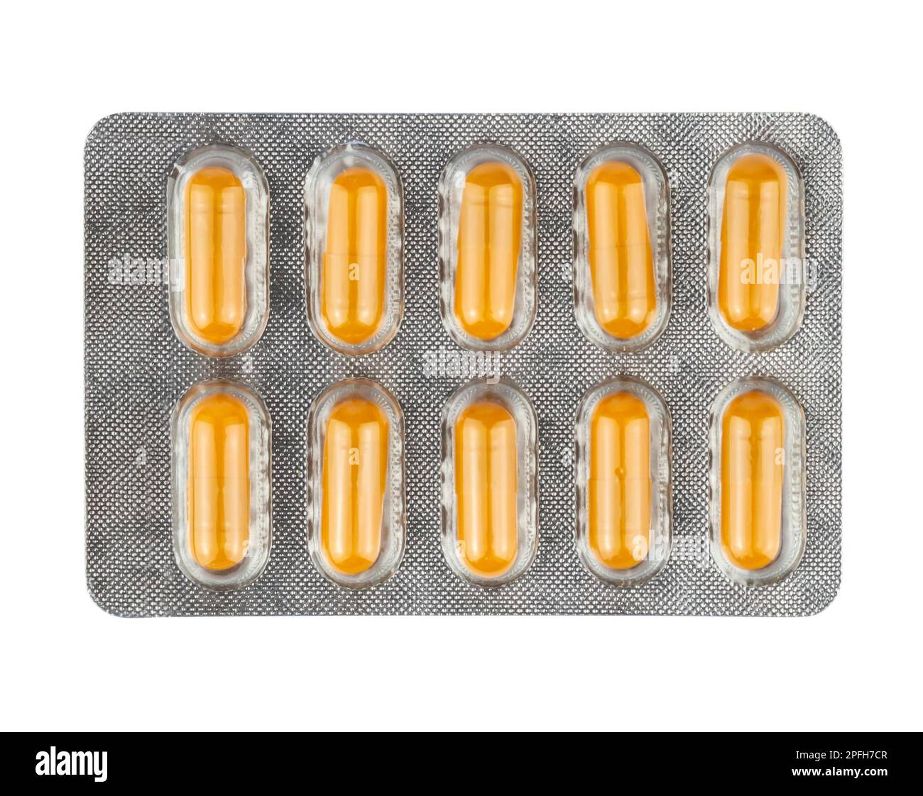 Yellow pills in a plastic blister package on white background Stock Photo