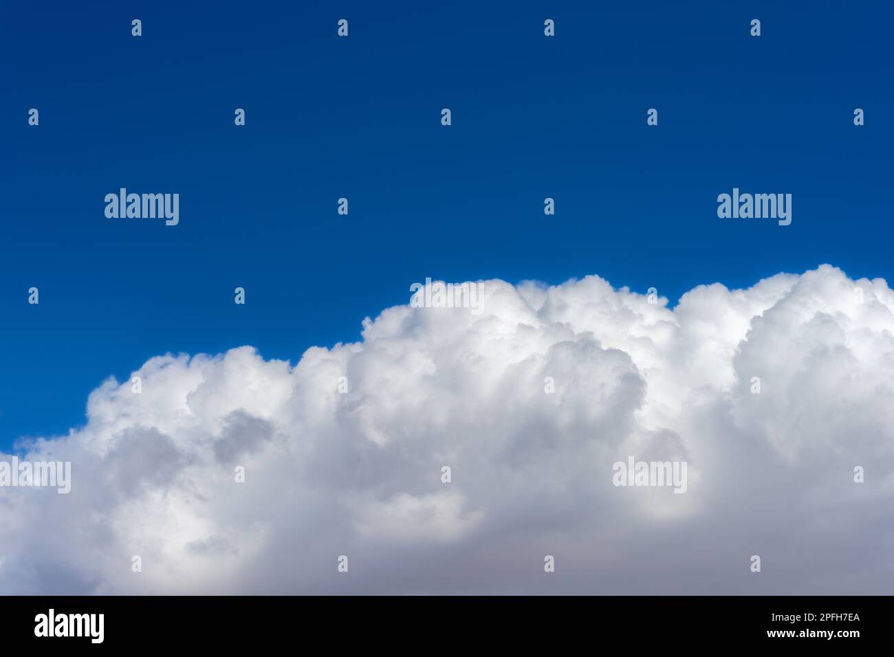 Puffy cumulonimbus cloud with a blue sky Stock Photo