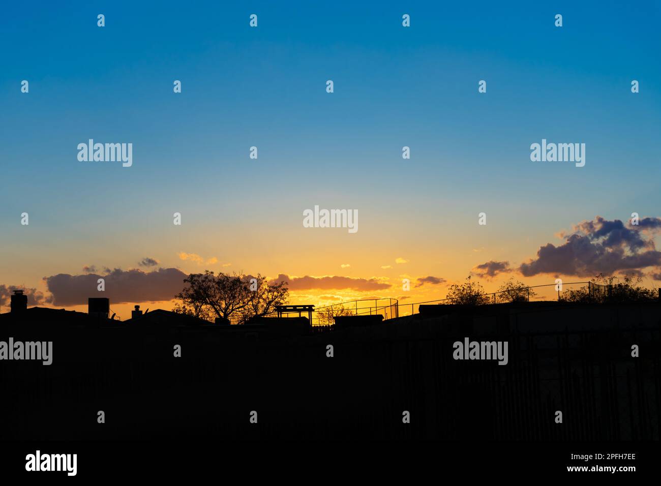 Sunset with rural landscape silhouette and golden blue sky Stock Photo ...
