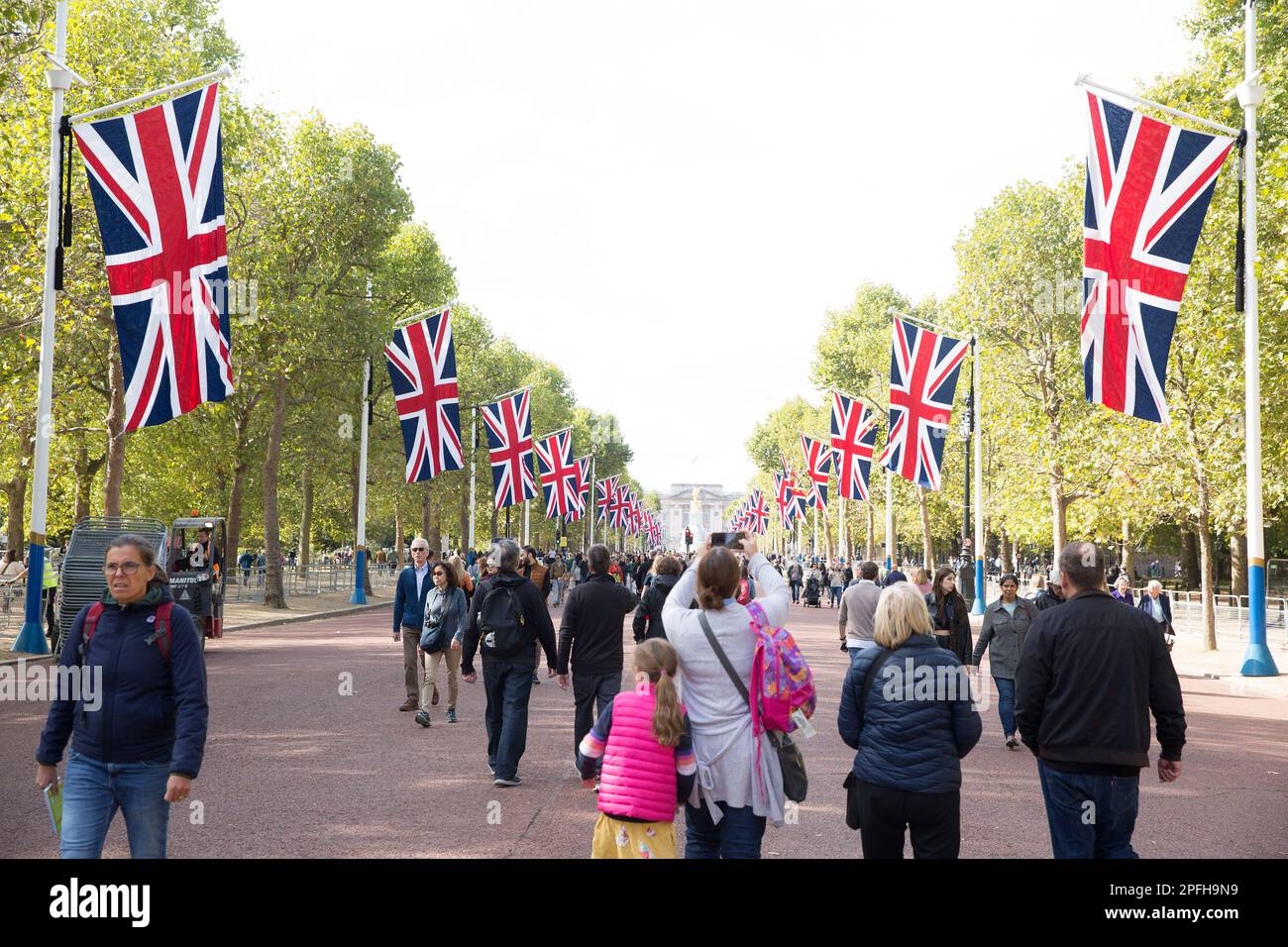 People walk on The Mall in London as many people gather around Buckingham Palace on the first Saturday since the state funeral of Queen Elizabeth II. Stock Photo