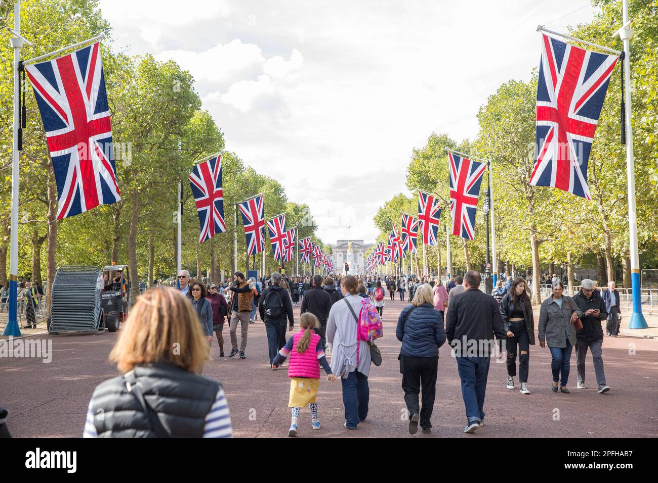 People walk on The Mall in London as many people gather around Buckingham Palace on the first Saturday since the state funeral of Queen Elizabeth II. Stock Photo