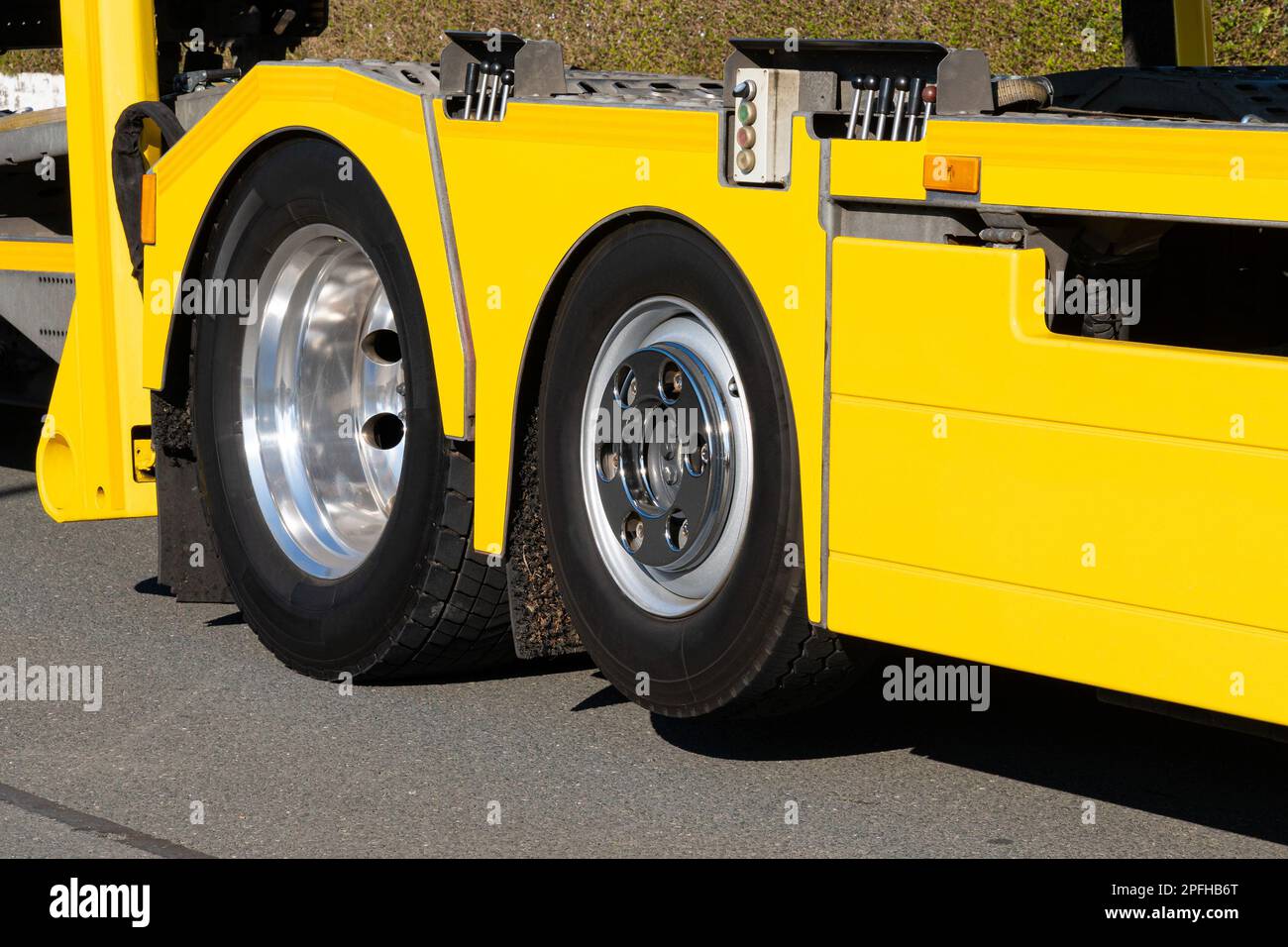 View on truck wheels and tires on yellow truck chassis. Truck wheel rim