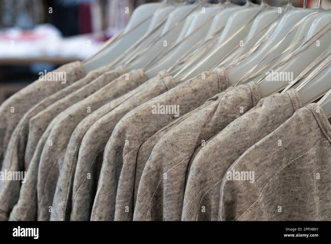 Fashion Women Clothes Hanging On Plastic Hangers In Clothing Store Department Store. Closeup. Casual wear. Stock Photo
