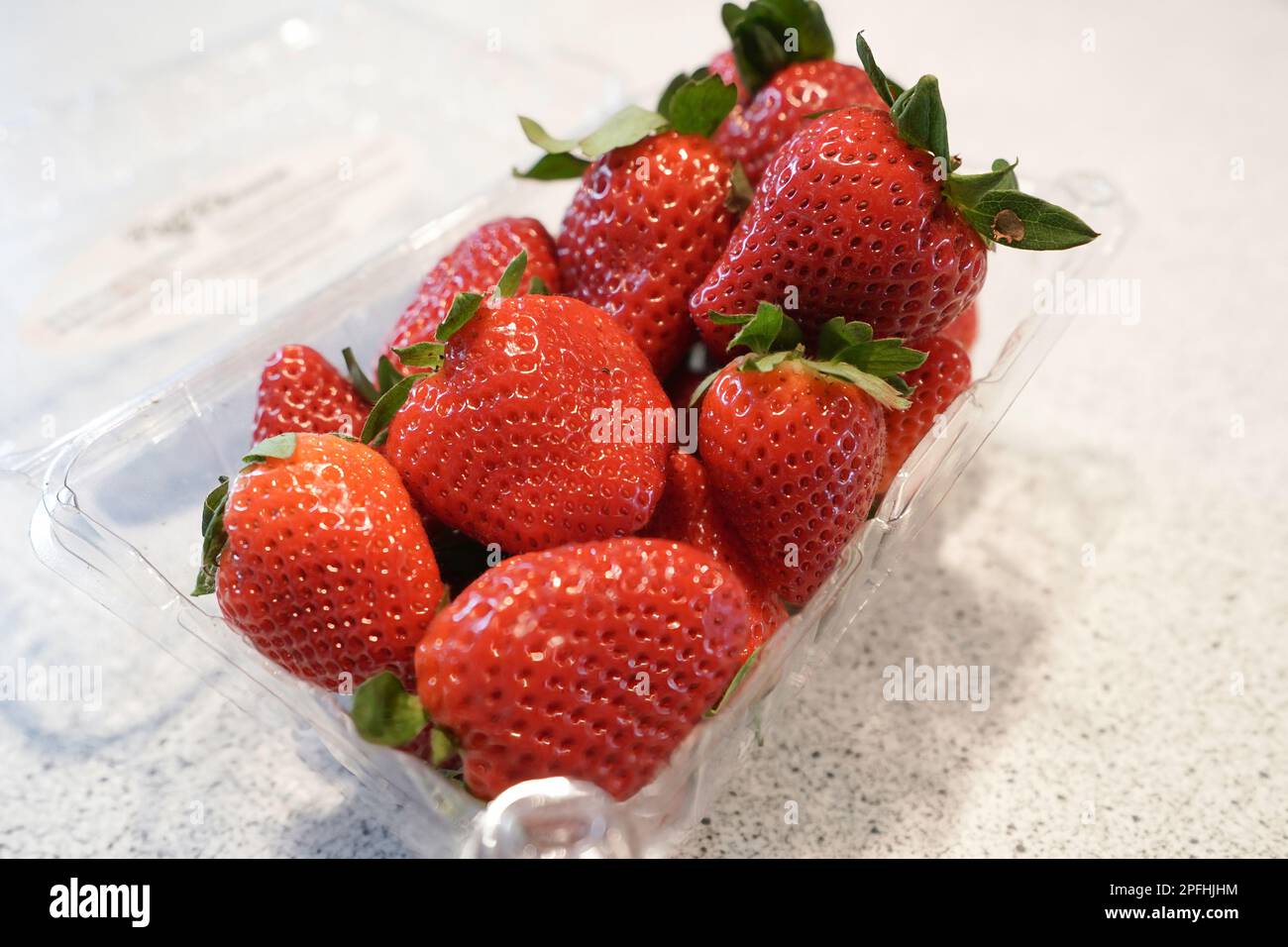Container of strawberries on kitchen counter Stock Photo Alamy