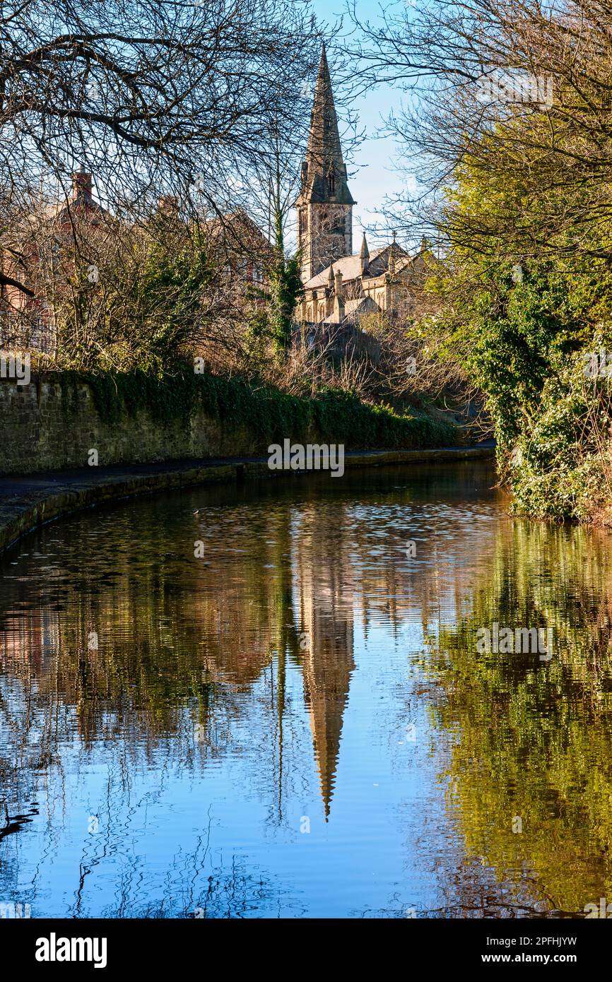 The spire of the Church of Saint Stephen reflected in the Ashton Canal. Guide Bridge, Ashton