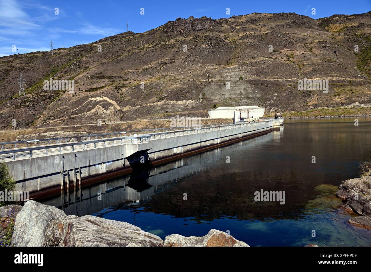 Clyde Dam on the Clutha River, in Central Otago, South Island, New Zealand. It is the largest concrete gravity dam in New Zealand. Stock Photo
