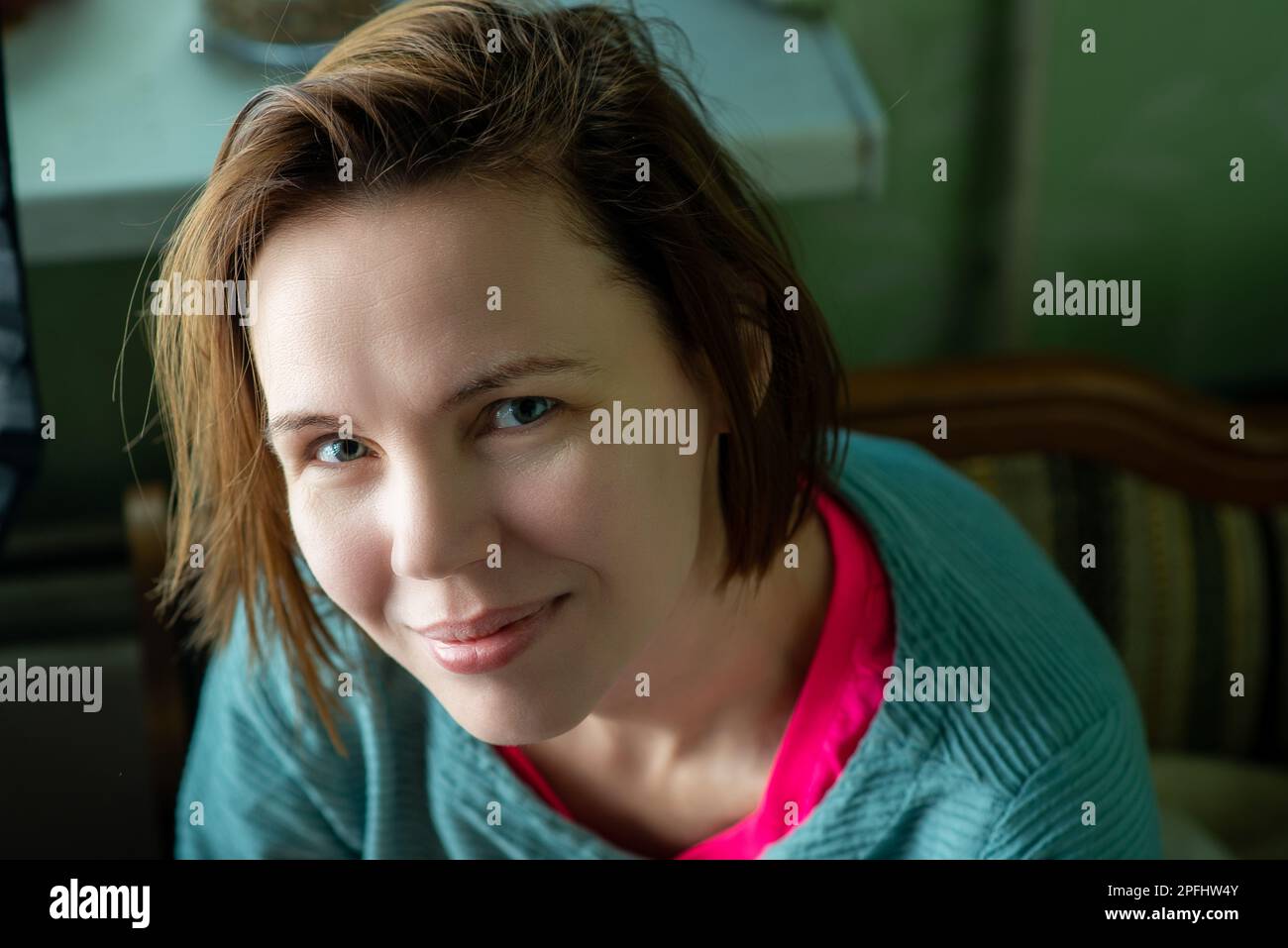 Happy smiling middle aged woman, forty years old. Ordinary woman without make-up at home. Stock Photo