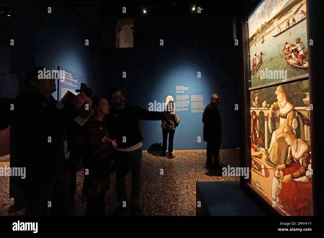 Visitors take photos of 'The Hunt in the Lagoon' and 'Two Venetian Ladies', a single painting on a door created by Vittore Carpaccio in 1492 and now finally recomposed after their separation in the late 17th century, today 17 March 2023 at the preview for the print at Palazzo Ducale. © ANDREA MEROLA Visitors take photos of 'The Hunt in the Lagoon' and 'Two Venetian Ladies', a single painting on a door created by Vittore Carpaccio in 1492 and now finally recomposed after their separation in the late 17th century, today 17 March 2023 at the preview for the print at Palazzo Ducale. © Andrew MEROL Stock Photo