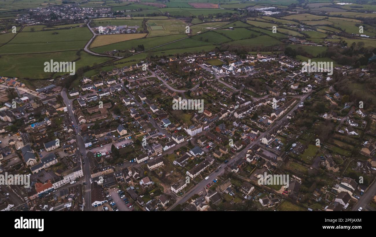 Aerial view of neighborhood surrounded by green landscape Stock Photo ...