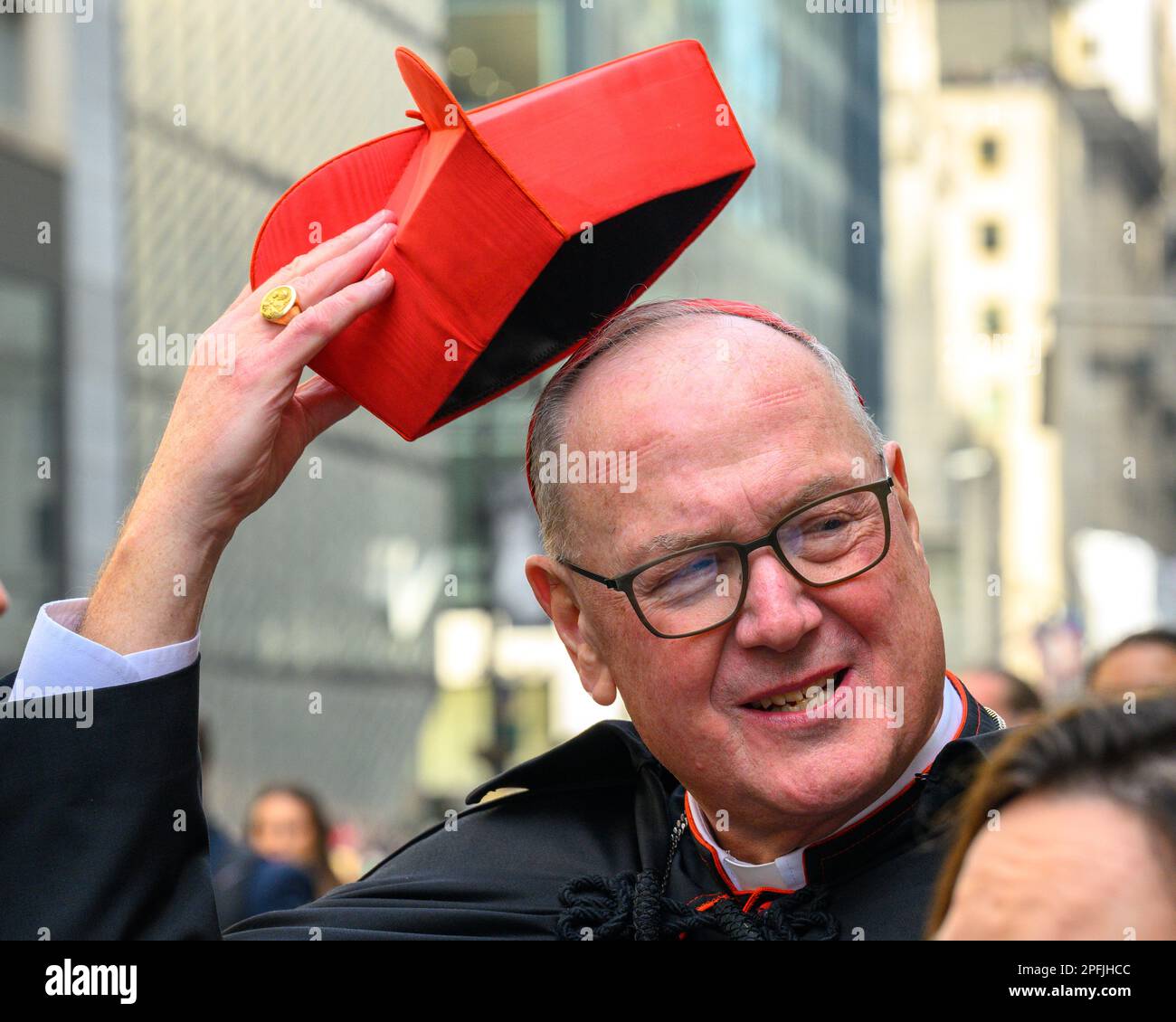 New York, USA. 17th Mar, 2023. New York city Cardinal Timothy Dolan lifts up his hat in front of St. Patrick's Cathedral during the St. Patrick's Day parade on March 17, 2023. About 150,000 people march through Fifth Avenue every year in the largest the St. Patrick's Day Parade, who has been held annually since 1762 to celebrate Irish heritage. Credit: Enrique Shore/Alamy Live News Stock Photo