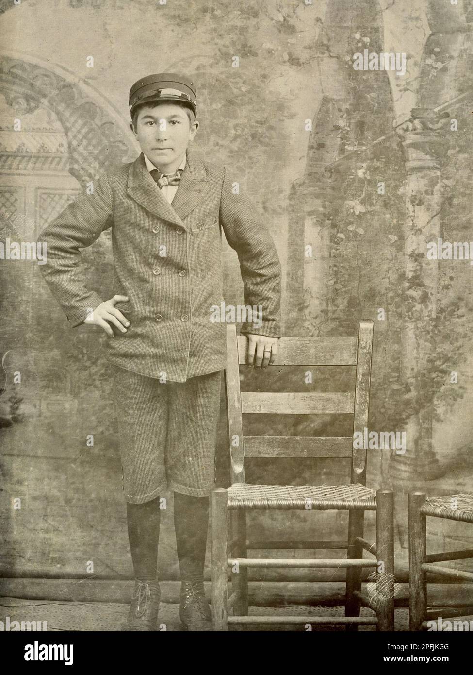 Child Labor 1900.  Child Worker. Boy in Uniform, Possibly a Messenger, Bell Hop, Baggage Handler, Porter Stock Photo