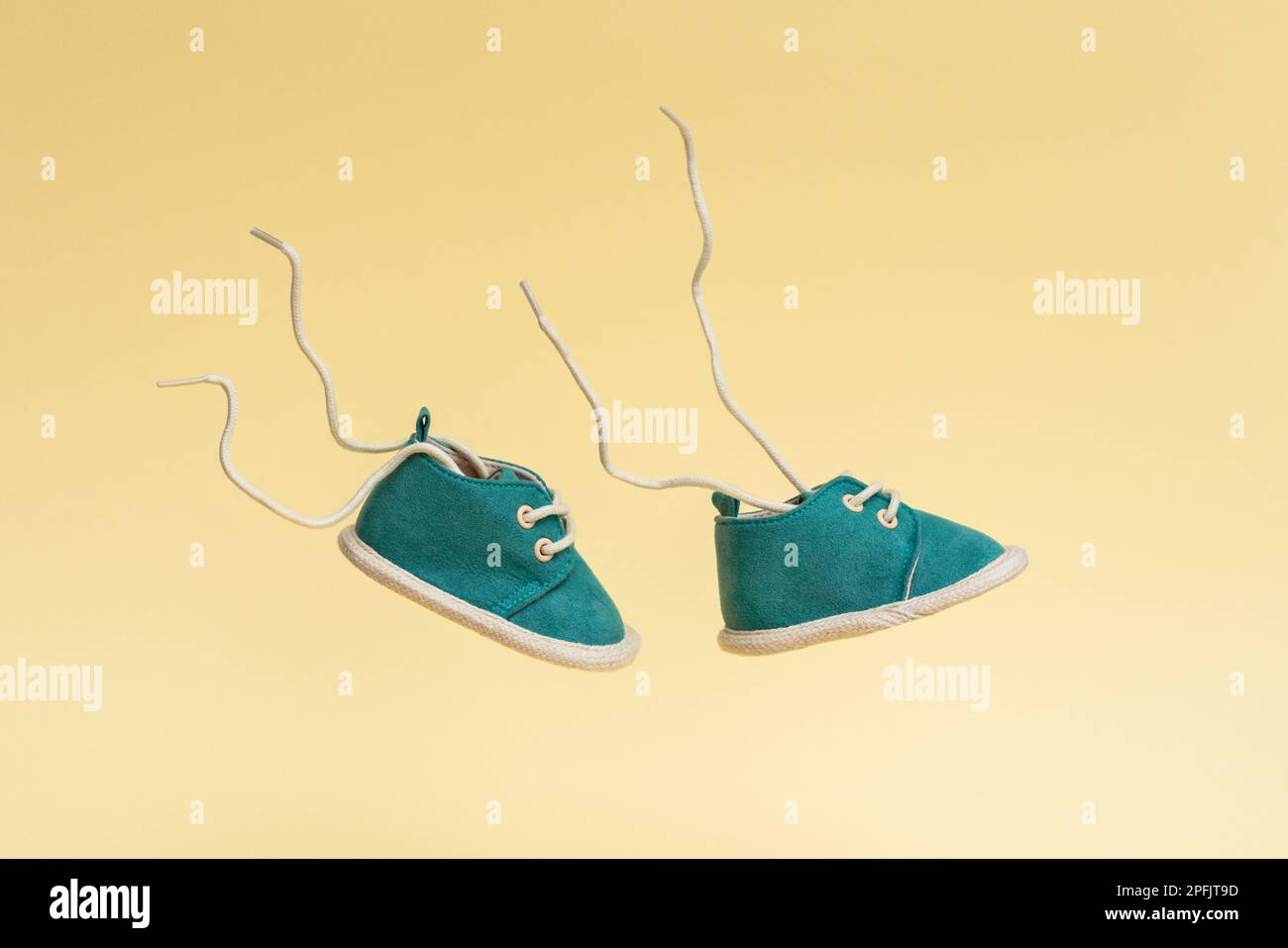 Flying baby shoes with flying laces. Newborn baby concept with levitation effect Stock Photo