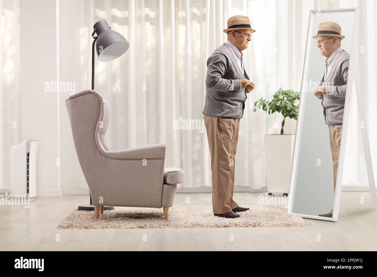 Full length shot of a senior gentleman getting dressed in front of a