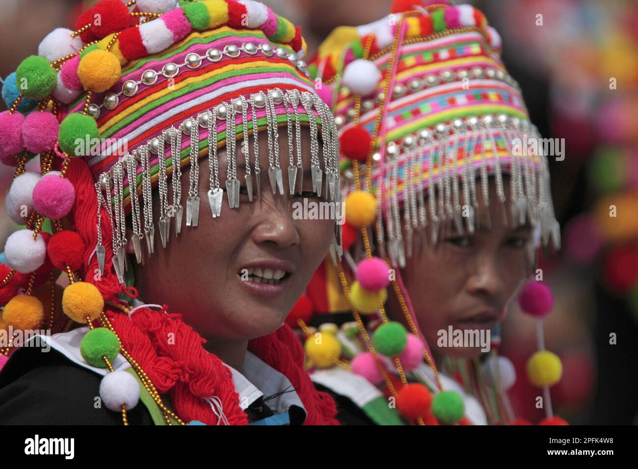 Lisu ethnic minority tribe, two dancers in traditional clothing, close-up of heads, Husa, West Yunnan, China Stock Photo