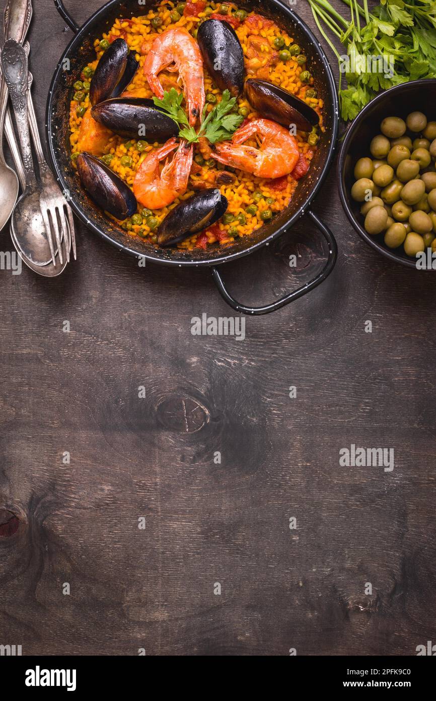 Paella background, space for text. Paella in black pan with saffron