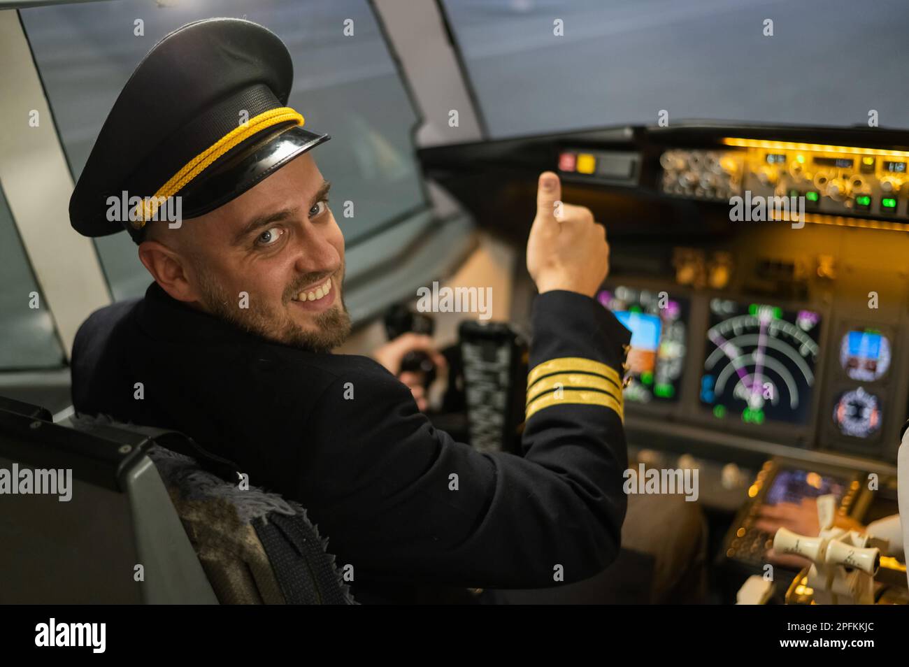 Caucasian bearded man smiling while driving a flight simulator. Pilot ...