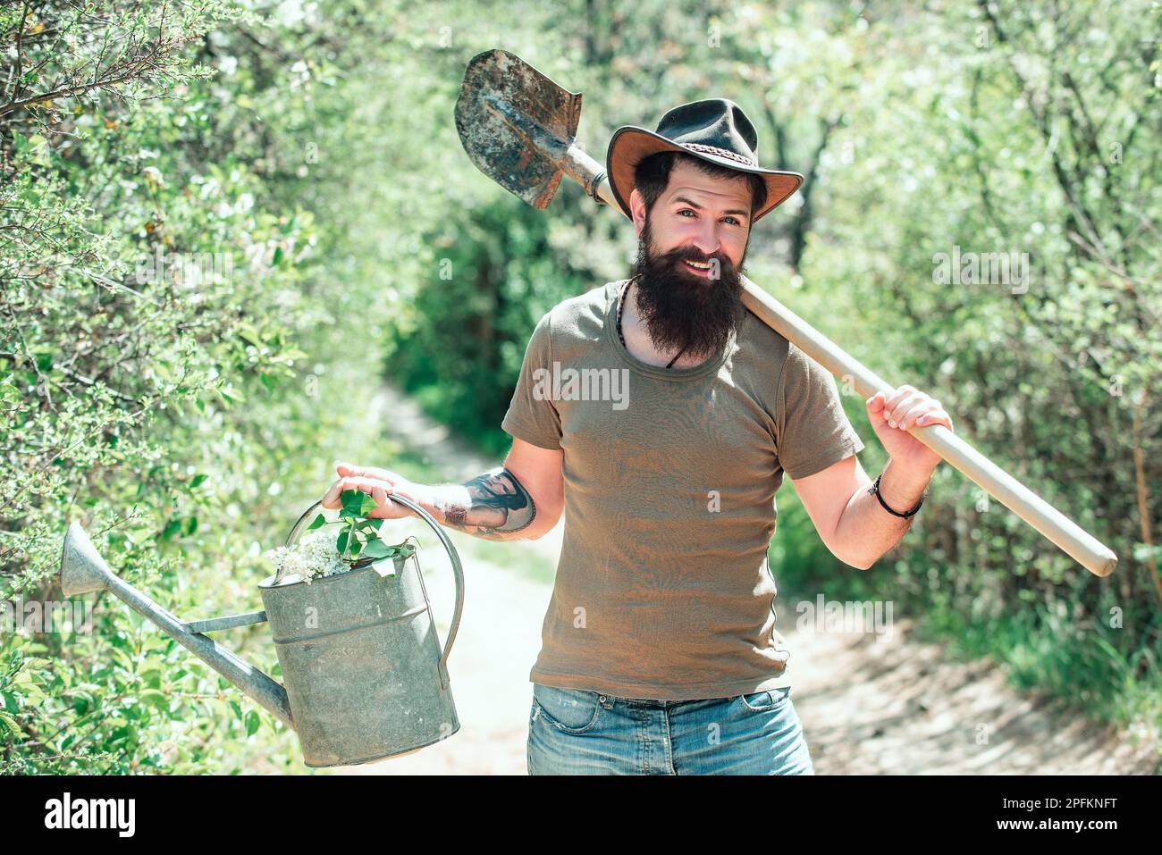 Become organic farmer. Farmer with Shovel and watering can Stock Photo ...