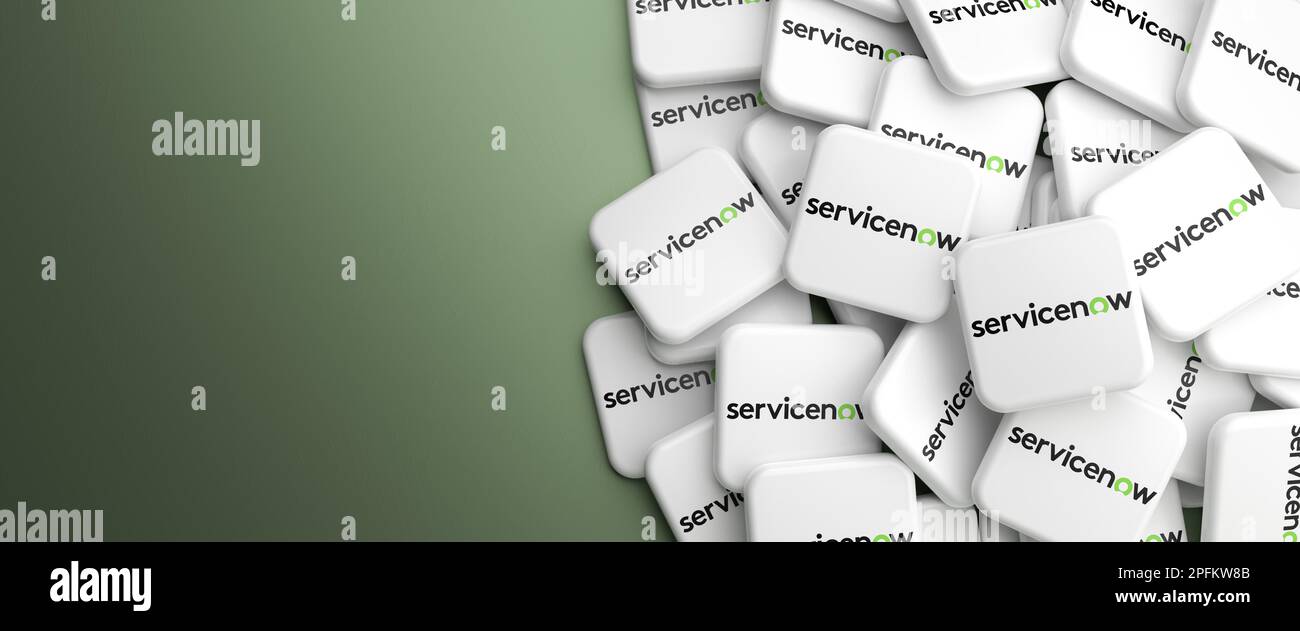 Logos of the software company ServiceNow on a heap on a table. Web banner format Stock Photo