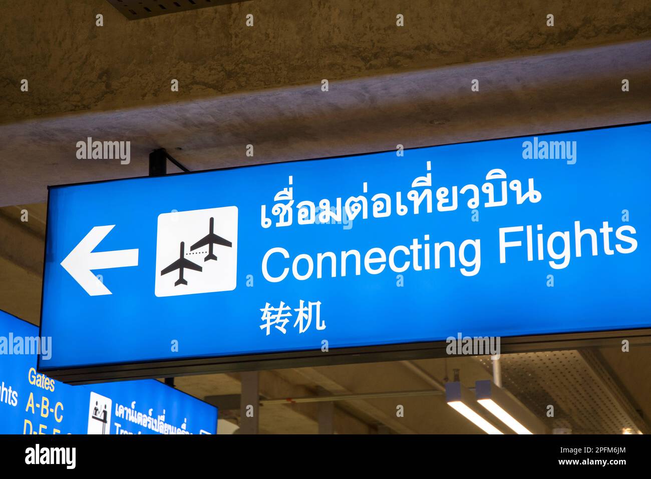 Airport signs for transfer and connecting flights in Thai, English and ...