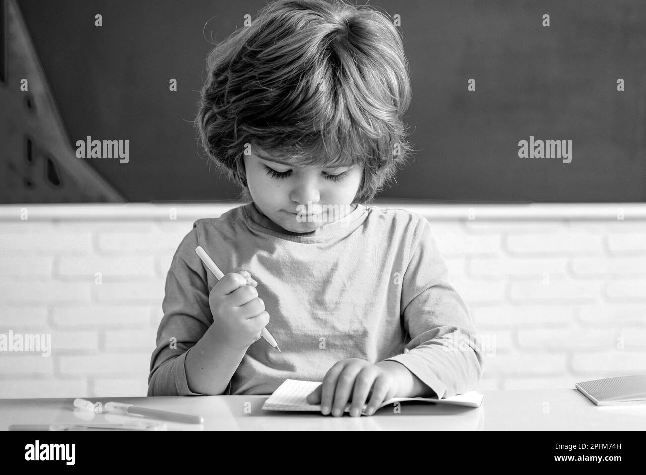 Back to school. School kids against green chalkboard. Individual tutoring. Education. Children learning. Stock Photo