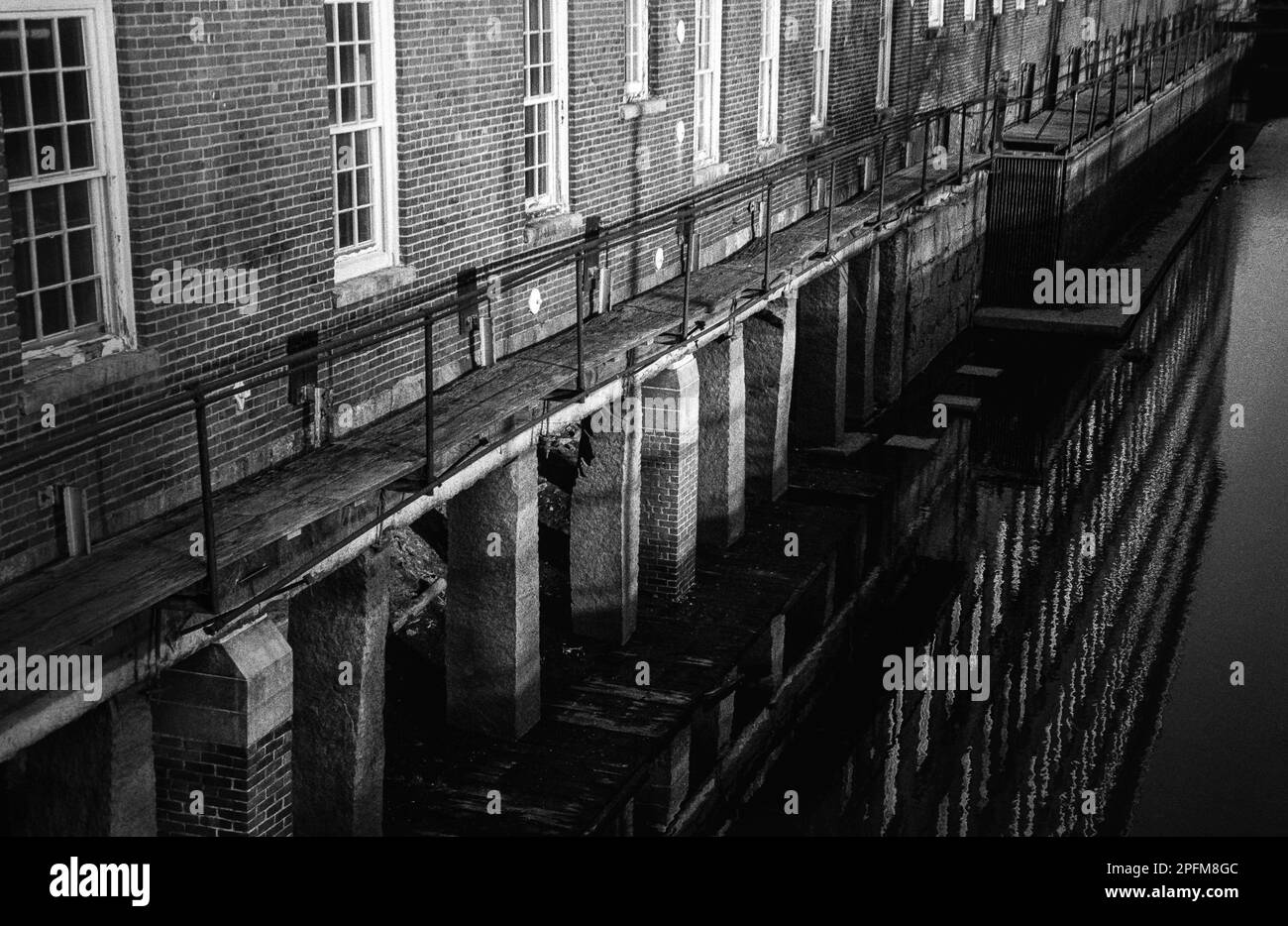 The reflection of the historic Boott Cotton Mills Museum and the canal