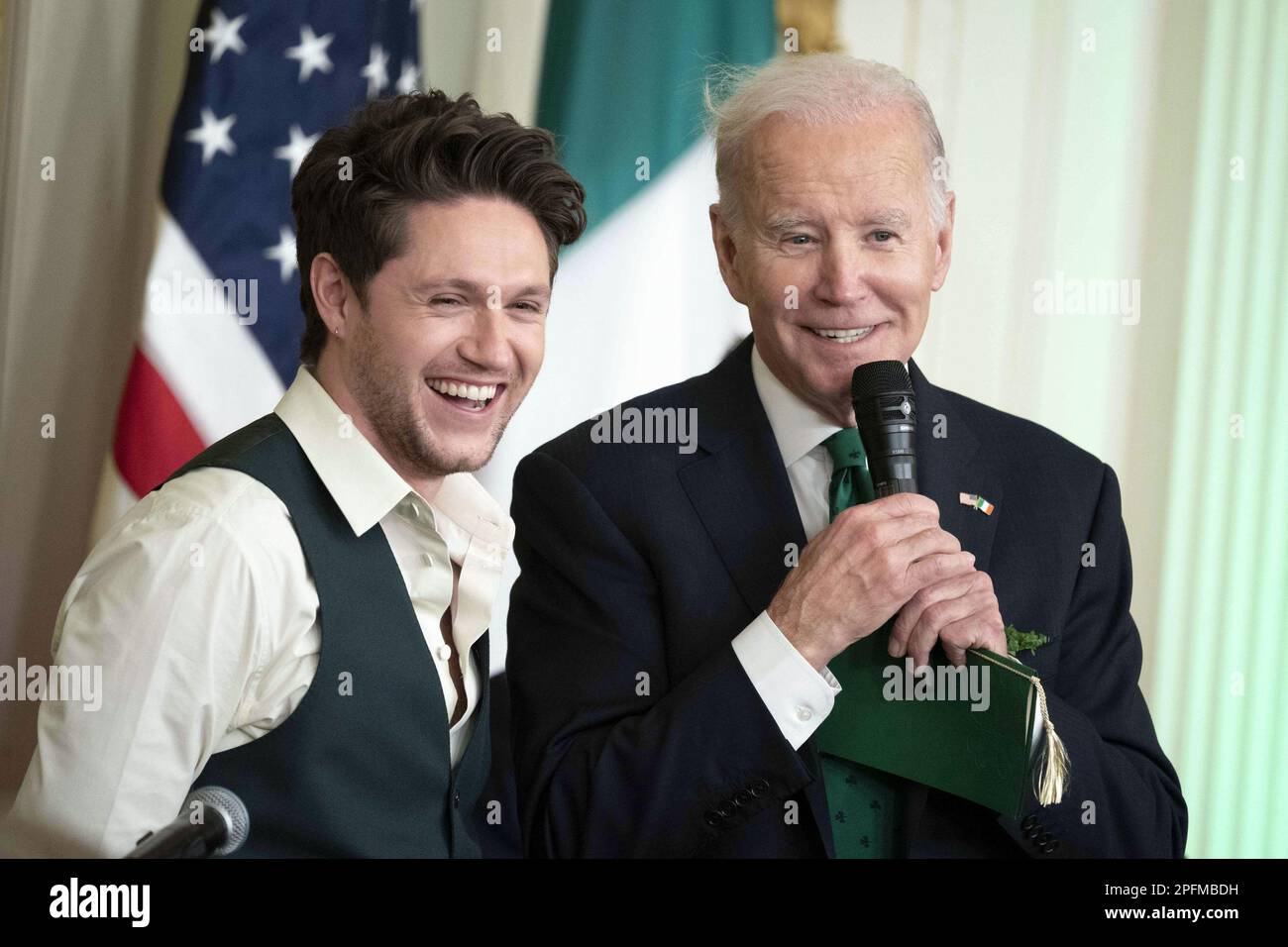 Washington, United States. 17th Mar, 2020. Irish Singer Niall Horan and President Joe Biden smile during a St. Patrick's Day reception and Shamrock presentation in the East Room of the White House in Washington, DC on Friday, March 17, 2023. Photo by Bonnie Cash/UPI Credit: UPI/Alamy Live News Stock Photo