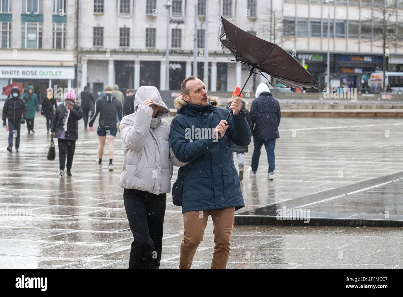 Nottingham, United Kingdom, Feb 18, 2022 - A pedestrian's umbrella was turned inside out by gales of Storm Eunice in Nottingham's Old Market Square. Stock Photo