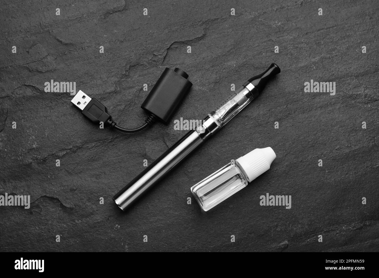 Electronic smoking device, charger and vaping liquid on black