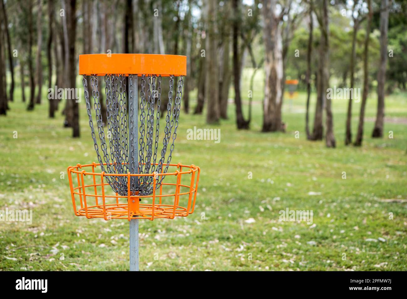 Closeup of disc golf (frolf) basket in a park obstacle course with a shallow depth of field Stock Photo