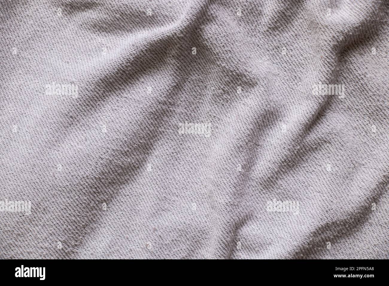 light gray cotton crumpled fabric as background close-up, fabric for background Stock Photo