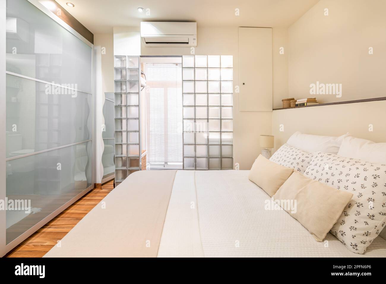 View of Original design of bright small bedroom with glass wall in the bathroom ...