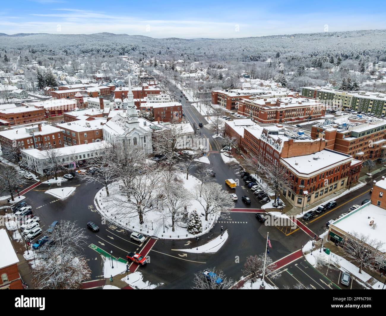 An aerial view of residential buildings and roads covered in the snow